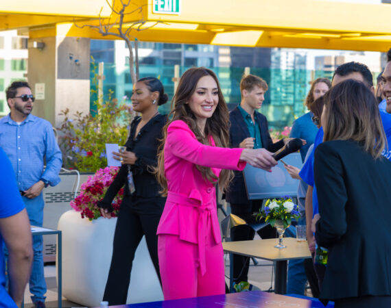 brightly dressed employee interviewing people