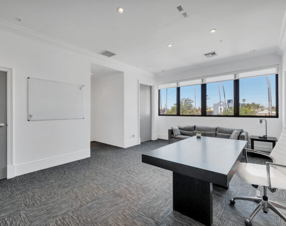 office room with windows and a couch